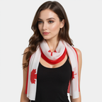 Woman wearing a white scarf with red patterns on a plain background